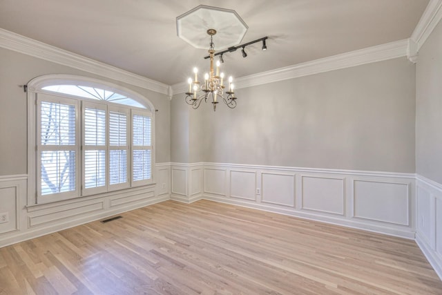 265 Stanley Park Ln, Franklin, TN 37069 - unfurnished room featuring a chandelier, light wood finished floors, a wainscoted wall, crown molding, and a decorative wall