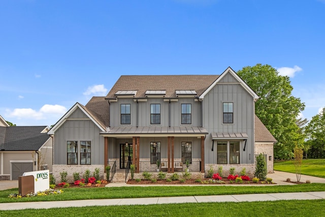 3005 Littlebury Park Dr, Thompsons Station, TN 37179 - modern farmhouse featuring board and batten siding, covered porch, a front lawn, and a standing seam roof