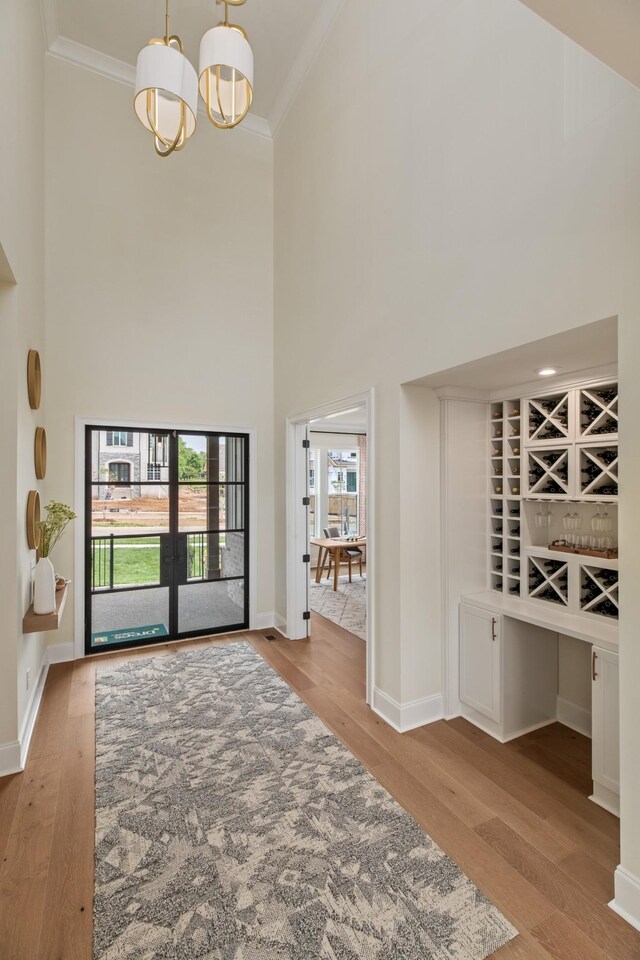 3005 Littlebury Park Dr, Thompsons Station, TN 37179 - entryway featuring a high ceiling, crown molding, a chandelier, and wood finished floors