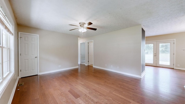 1726 Old Clarksville Pike, Chapmansboro, TN 37035 - empty room featuring wood finished floors, ceiling fan, and a textured ceiling