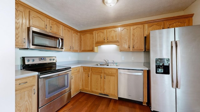 1726 Old Clarksville Pike, Chapmansboro, TN 37035 - kitchen with stainless steel appliances, dark wood finished floors, light countertops, and a textured ceiling