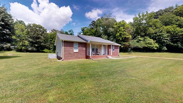1726 Old Clarksville Pike, Chapmansboro, TN 37035 - view of front of home featuring a front yard, covered porch, and brick siding