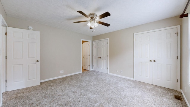 1726 Old Clarksville Pike, Chapmansboro, TN 37035 - unfurnished bedroom with two closets, carpet flooring, and a ceiling fan