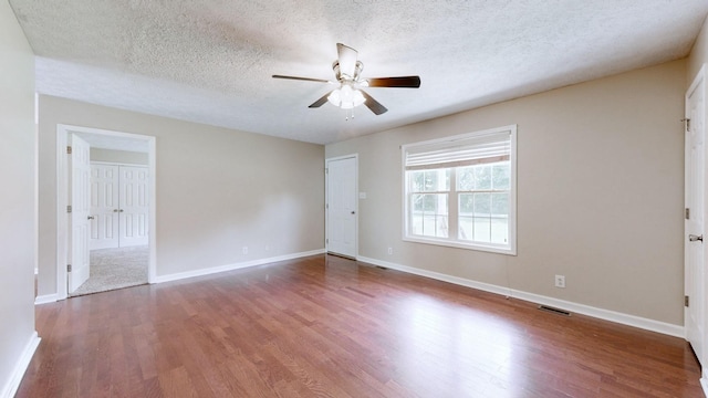 1726 Old Clarksville Pike, Chapmansboro, TN 37035 - empty room with ceiling fan, wood finished floors, and a textured ceiling