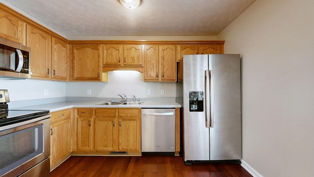 1726 Old Clarksville Pike, Chapmansboro, TN 37035 - kitchen with appliances with stainless steel finishes, light countertops, dark wood-type flooring, and a textured ceiling