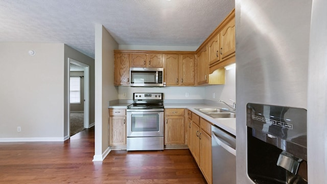 1726 Old Clarksville Pike, Chapmansboro, TN 37035 - kitchen featuring stainless steel appliances, dark wood-style flooring, light countertops, and a textured ceiling