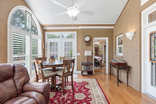 2208 Chadwick Ct, Mount Juliet, TN 37122 - dining space with ceiling fan, brick wall, light wood-type flooring, high vaulted ceiling, and crown molding