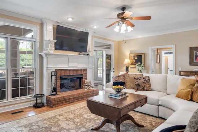 2208 Chadwick Ct, Mount Juliet, TN 37122 - living room featuring crown molding, plenty of natural light, a ceiling fan, a fireplace, and wood finished floors