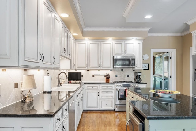 2208 Chadwick Ct, Mount Juliet, TN 37122 - kitchen with appliances with stainless steel finishes, ornamental molding, decorative backsplash, white cabinets, and recessed lighting