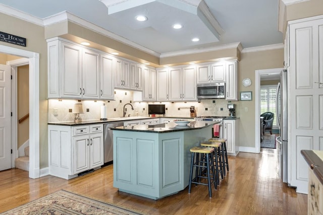 2208 Chadwick Ct, Mount Juliet, TN 37122 - kitchen with appliances with stainless steel finishes, dark countertops, ornamental molding, backsplash, and wood finished floors