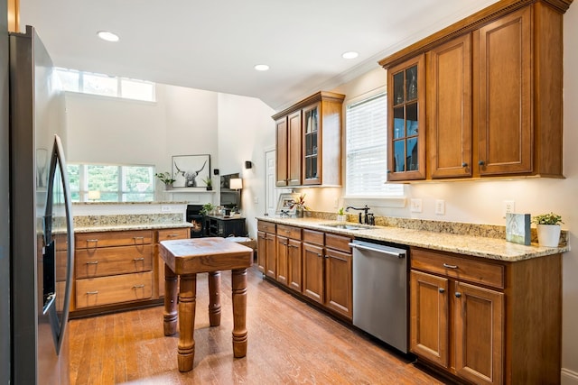 368 Pennystone Cir, Franklin, TN 37067 - kitchen featuring stainless steel appliances, brown cabinetry, light wood-type flooring, and recessed lighting