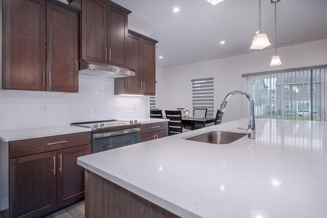 1401 Kennebec Dr, Smyrna, TN 37167 - kitchen featuring electric stove, under cabinet range hood, decorative backsplash, decorative light fixtures, and dark brown cabinets