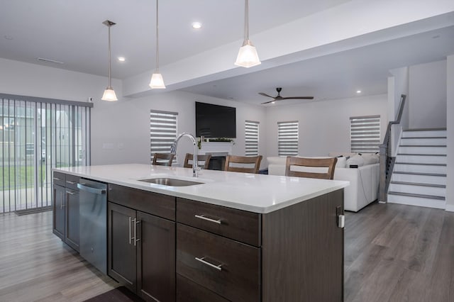 1401 Kennebec Dr, Smyrna, TN 37167 - kitchen featuring stainless steel dishwasher, open floor plan, wood finished floors, a ceiling fan, and light countertops