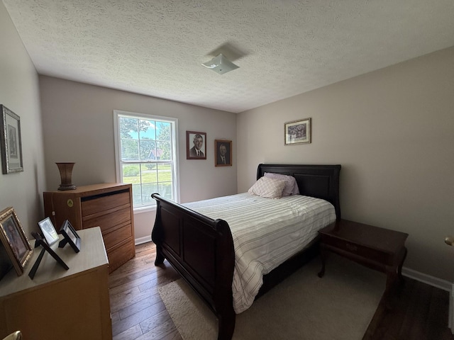 242 Kay Cir, Lafayette, TN 37083 - bedroom with dark wood finished floors and a textured ceiling