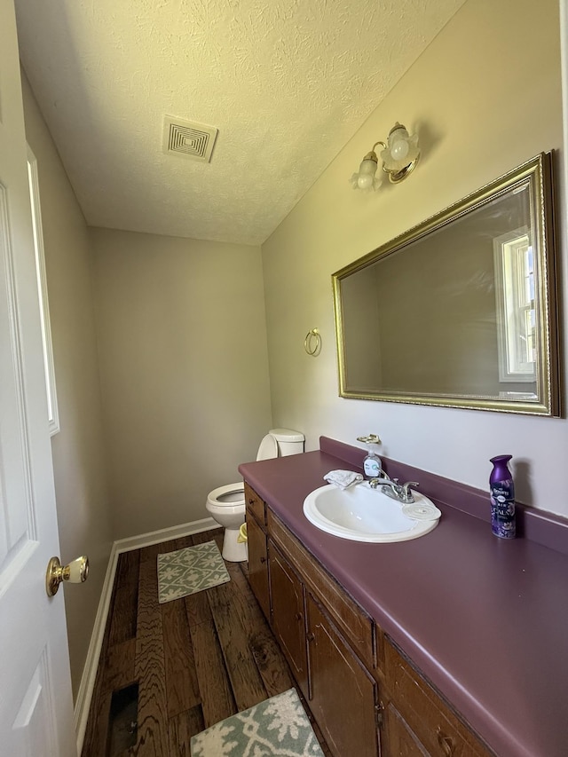 242 Kay Cir, Lafayette, TN 37083 - half bathroom with vanity, wood finished floors, and a textured ceiling