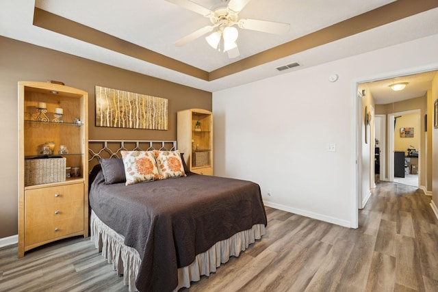 1652 Saint Andrews Dr, Murfreesboro, TN 37128 - bedroom featuring wood finished floors, a tray ceiling, and ceiling fan