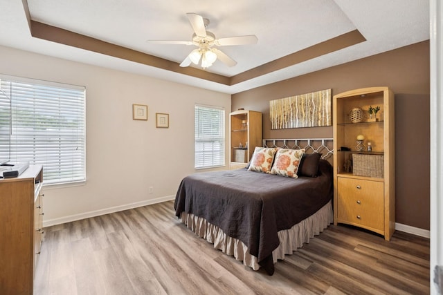 1652 Saint Andrews Dr, Murfreesboro, TN 37128 - bedroom with wood finished floors, a tray ceiling, and ceiling fan