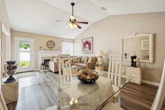 1652 Saint Andrews Dr, Murfreesboro, TN 37128 - dining space with vaulted ceiling, a ceiling fan, wood finished floors, and a lit fireplace
