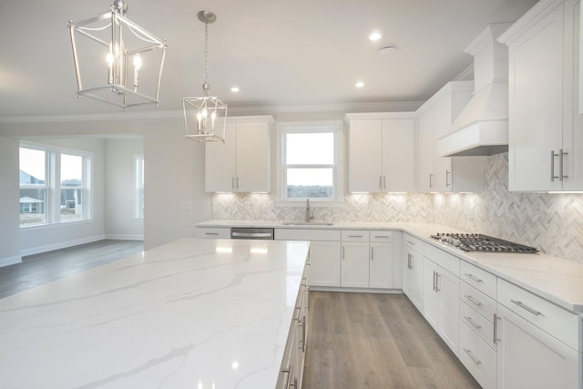 3294 Camden Ct, Mount Juliet, TN 37122 - kitchen with premium range hood, stainless steel appliances, ornamental molding, a chandelier, and white cabinetry