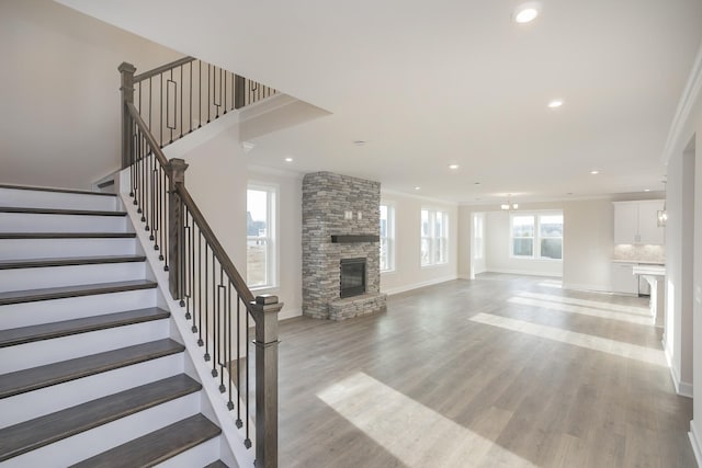 3294 Camden Ct, Mount Juliet, TN 37122 - unfurnished living room featuring a fireplace, recessed lighting, stairway, light wood-style flooring, and ornamental molding