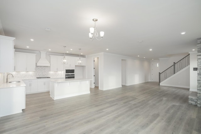 3294 Camden Ct, Mount Juliet, TN 37122 - unfurnished living room with recessed lighting, light wood-style floors, a chandelier, and stairway