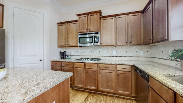 166 Azalea Ln, Franklin, TN 37064 - kitchen with appliances with stainless steel finishes, crown molding, light wood finished floors, tasteful backsplash, and light stone counters
