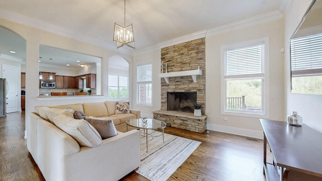 166 Azalea Ln, Franklin, TN 37064 - living room with plenty of natural light, crown molding, wood finished floors, a fireplace, and arched walkways