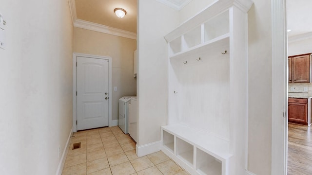 166 Azalea Ln, Franklin, TN 37064 - mudroom featuring washer and clothes dryer, ornamental molding, and light tile patterned flooring