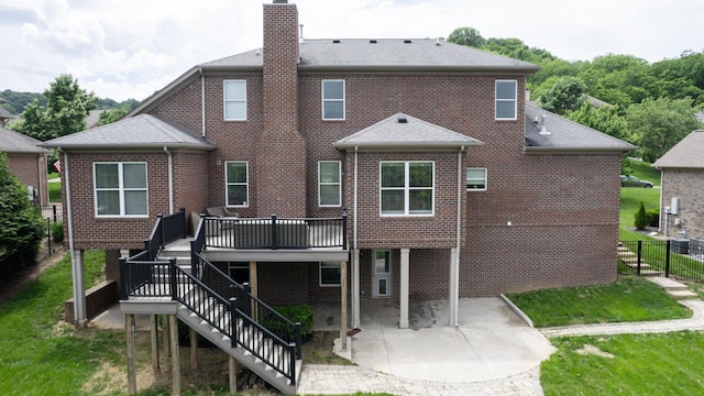 166 Azalea Ln, Franklin, TN 37064 - back of property with a patio, a chimney, roof with shingles, and brick siding