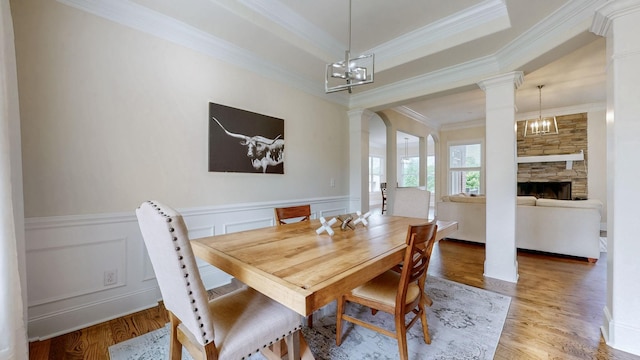 166 Azalea Ln, Franklin, TN 37064 - dining area with ornate columns, ornamental molding, light wood-type flooring, a chandelier, and a wainscoted wall