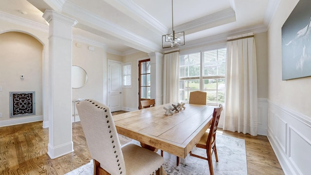 166 Azalea Ln, Franklin, TN 37064 - dining room with decorative columns, ornamental molding, light wood-style floors, arched walkways, and wainscoting