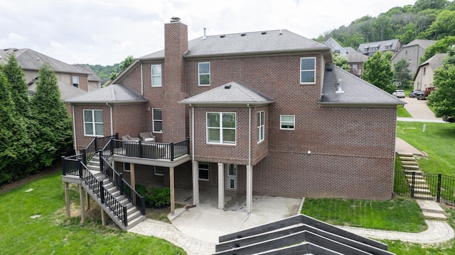 166 Azalea Ln, Franklin, TN 37064 - rear view of house with stairs, a patio area, a chimney, a deck, and brick siding