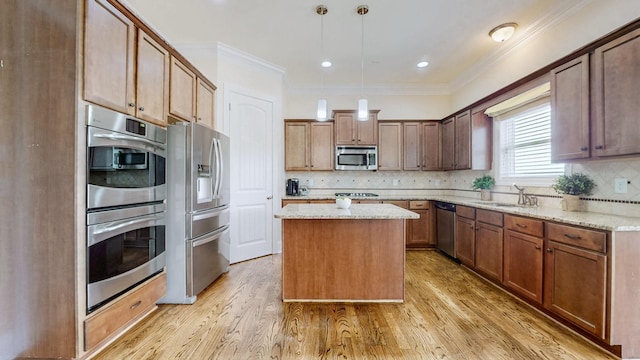 166 Azalea Ln, Franklin, TN 37064 - kitchen with appliances with stainless steel finishes, a kitchen island, decorative backsplash, crown molding, and light wood-type flooring