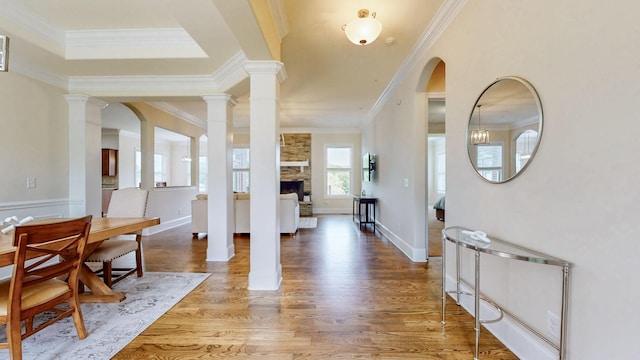 166 Azalea Ln, Franklin, TN 37064 - entryway with ornamental molding, wood finished floors, decorative columns, a large fireplace, and arched walkways