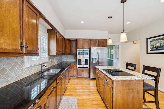 410 Ridge View Ct, Franklin, TN 37067 - kitchen with stainless steel appliances, light wood finished floors, tasteful backsplash, a kitchen bar, and recessed lighting