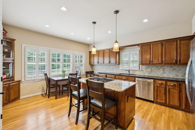 410 Ridge View Ct, Franklin, TN 37067 - kitchen with dishwasher, light wood-style flooring, backsplash, plenty of natural light, and recessed lighting