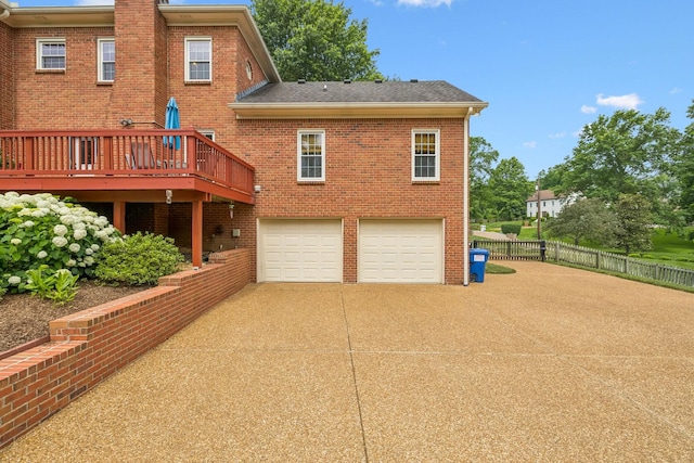 410 Ridge View Ct, Franklin, TN 37067 - rear view of house featuring driveway, brick siding, an attached garage, roof with shingles, and a deck
