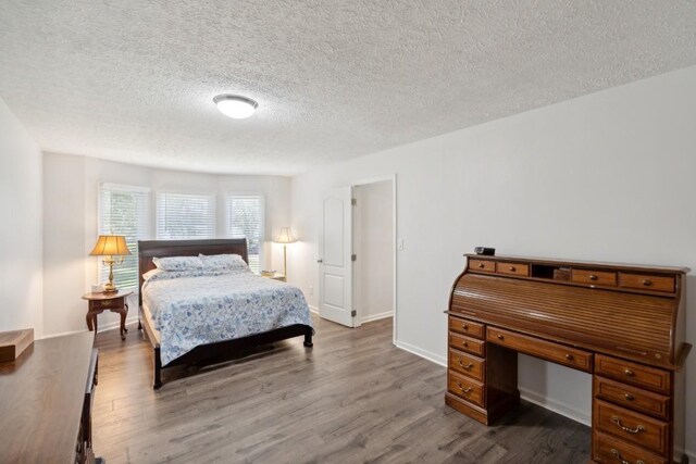 3448 Mahlon Moore Rd, Spring Hill, TN 37174 - bedroom featuring wood finished floors and a textured ceiling