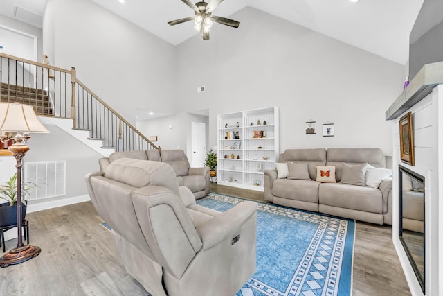 541 Macy Lynn Dr, Clarksville, TN 37042 - living area with wood finished floors, ceiling fan, high vaulted ceiling, and stairs