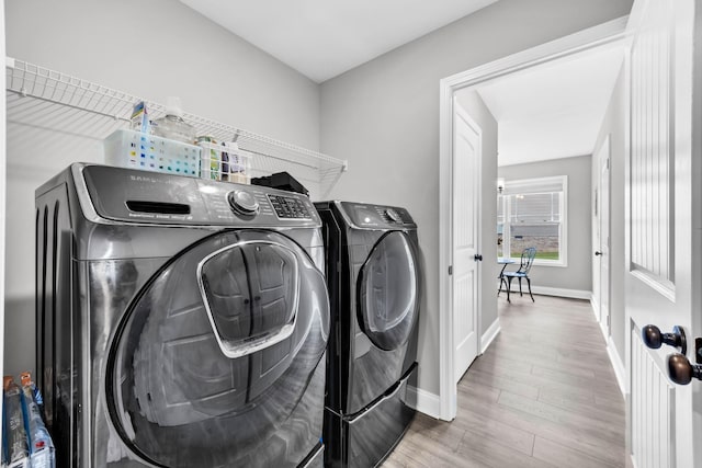 541 Macy Lynn Dr, Clarksville, TN 37042 - laundry area featuring washer and clothes dryer and wood finished floors
