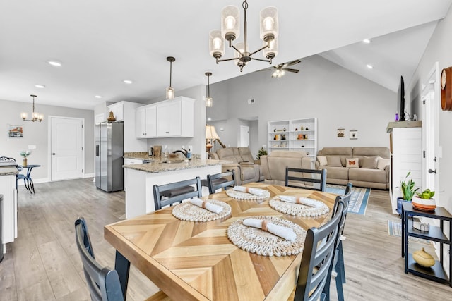 541 Macy Lynn Dr, Clarksville, TN 37042 - dining area with a chandelier, light wood-style flooring, recessed lighting, ceiling fan, and high vaulted ceiling
