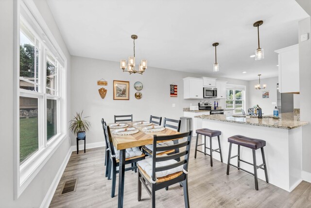 541 Macy Lynn Dr, Clarksville, TN 37042 - dining area featuring a chandelier and light wood finished floors