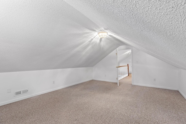 14319 Bluffview Dr, Birchwood, TN 37308 - bonus room with a textured ceiling, lofted ceiling, and light colored carpet