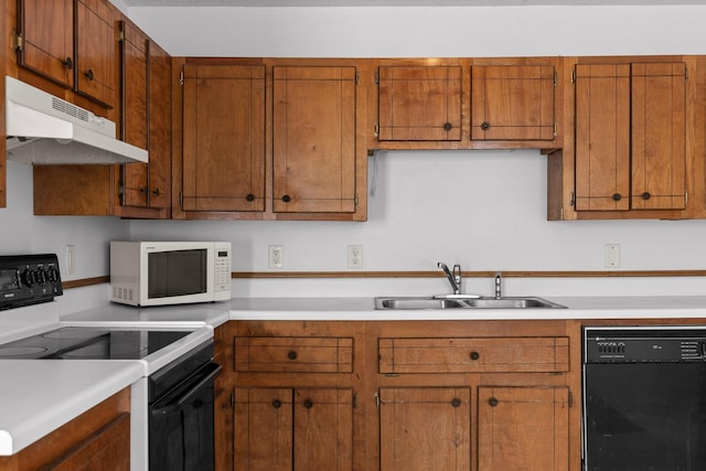 14319 Bluffview Dr, Birchwood, TN 37308 - kitchen with black appliances, under cabinet range hood, light countertops, and brown cabinets