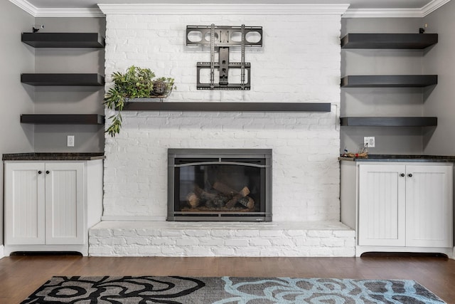 9321 Hopi Trl, Ooltewah, TN 37363 - unfurnished living room featuring wood finished floors, crown molding, and a fireplace