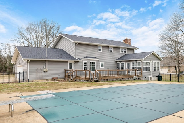 9321 Hopi Trl, Ooltewah, TN 37363 - back of house with a wooden deck, a sunroom, a garage, and a chimney