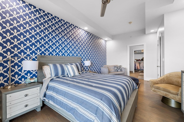 4 Cherokee Blvd Unit 409, Chattanooga, TN 37405 - bedroom featuring wallpapered walls, an accent wall, a walk in closet, recessed lighting, and wood finished floors
