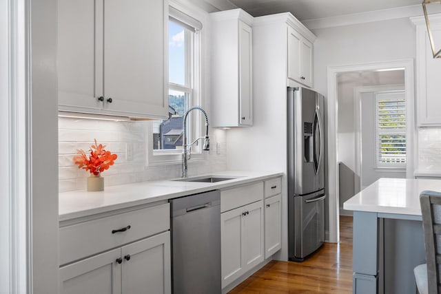 2305 Weeping Willow Dr, Ooltewah, TN 37363 - kitchen featuring appliances with stainless steel finishes, wood finished floors, light countertops, backsplash, and white cabinetry