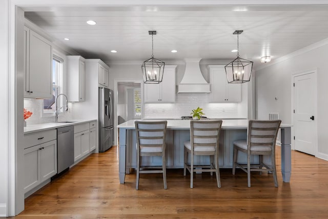 2305 Weeping Willow Dr, Ooltewah, TN 37363 - kitchen featuring custom range hood, stainless steel appliances, backsplash, light countertops, and crown molding