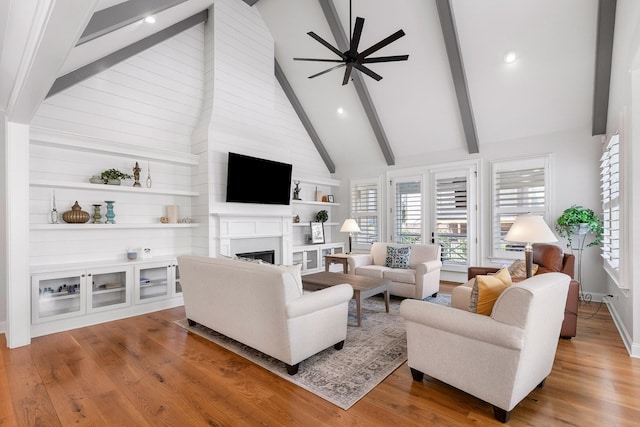 2305 Weeping Willow Dr, Ooltewah, TN 37363 - living area featuring beam ceiling, a fireplace, ceiling fan, plenty of natural light, and wood finished floors